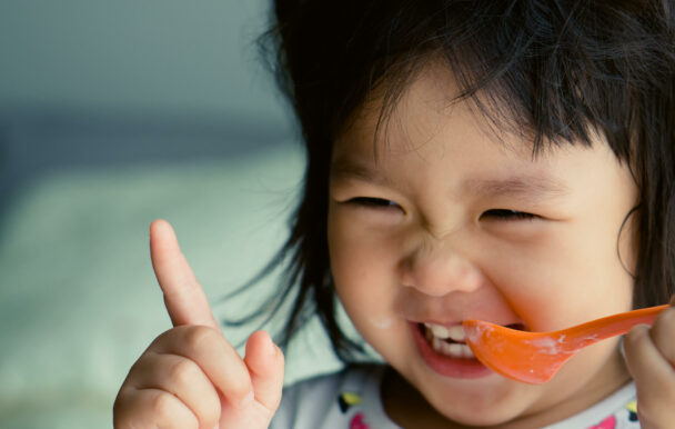 child holding spoon