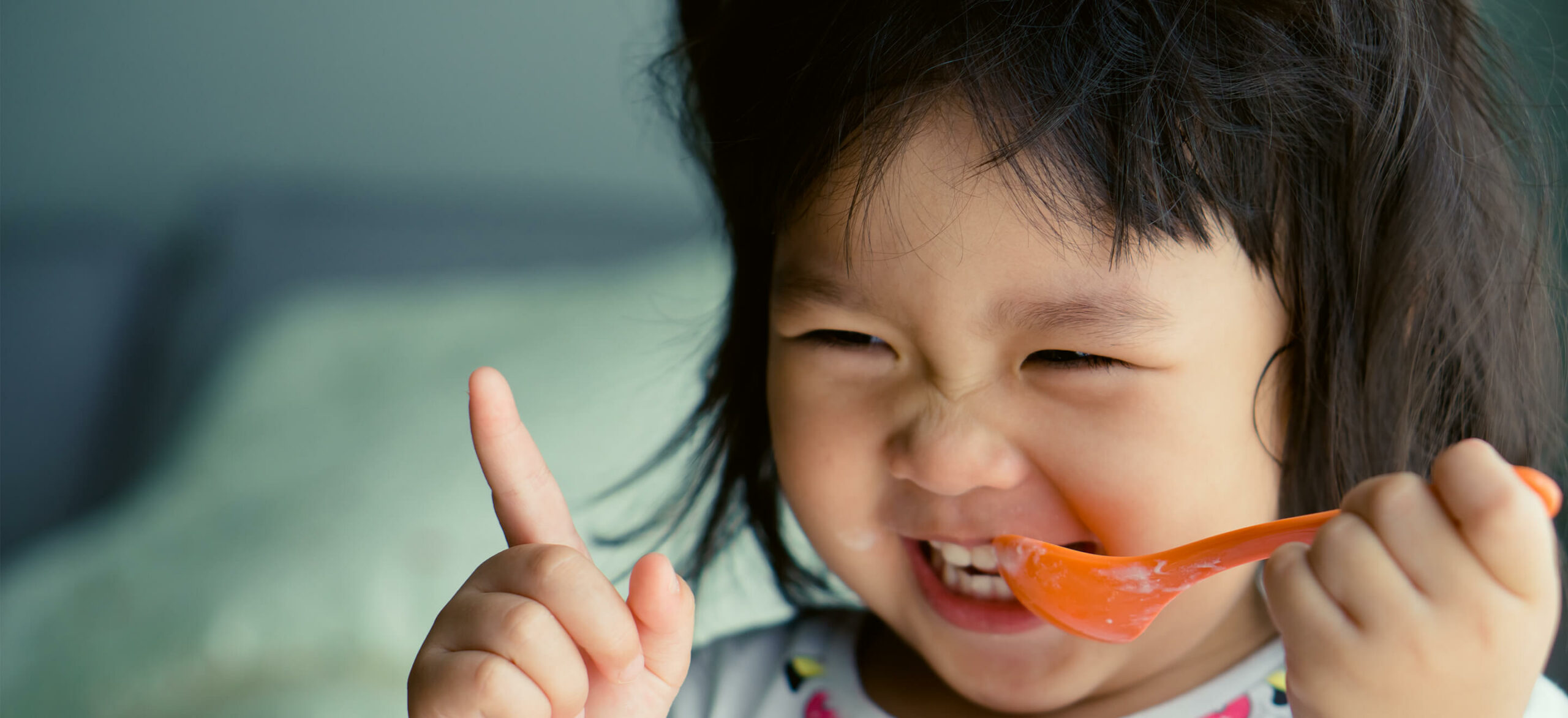 child holding spoon